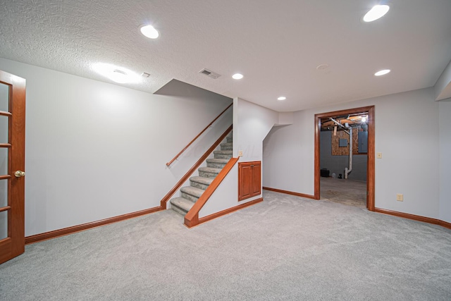 390 Engelwood Ct, Powell, OH 43065 - finished below grade area featuring light carpet, stairs, recessed lighting, and a textured ceiling
