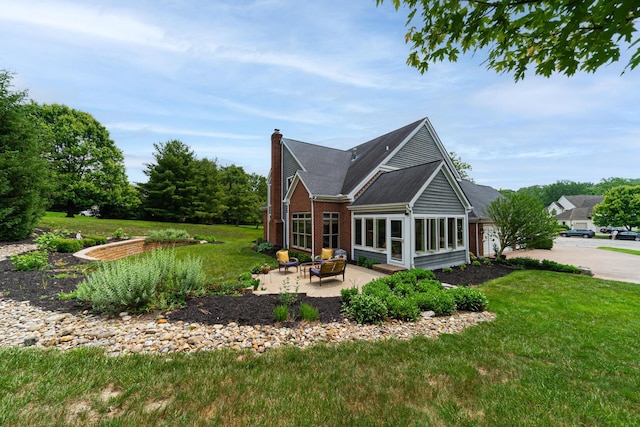 390 Engelwood Ct, Powell, OH 43065 - back of house featuring a chimney, a patio, a yard, and brick siding