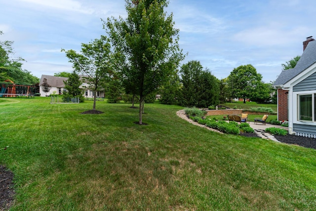 390 Engelwood Ct, Powell, OH 43065 - view of green lawn with a patio area and a playground