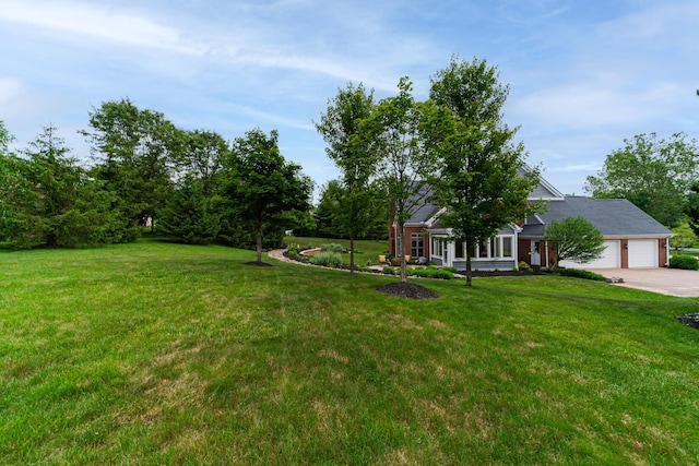 390 Engelwood Ct, Powell, OH 43065 - view of grassy yard with an attached garage and concrete driveway