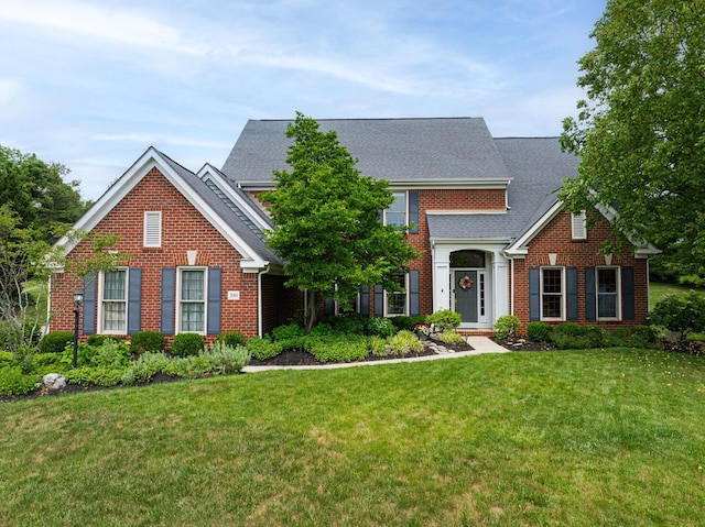 390 Engelwood Ct, Powell, OH 43065 - traditional home featuring brick siding, a front lawn, and a shingled roof