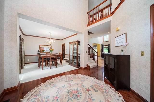 390 Engelwood Ct, Powell, OH 43065 - dining space with hardwood / wood-style flooring, a chandelier, crown molding, stairway, and wallpapered walls