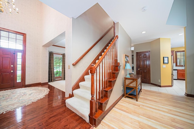 390 Engelwood Ct, Powell, OH 43065 - entrance foyer with wood finished floors, stairway, recessed lighting, a chandelier, and a high ceiling