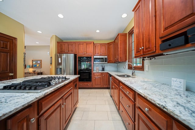 390 Engelwood Ct, Powell, OH 43065 - kitchen featuring appliances with stainless steel finishes, tasteful backsplash, light stone counters, and recessed lighting