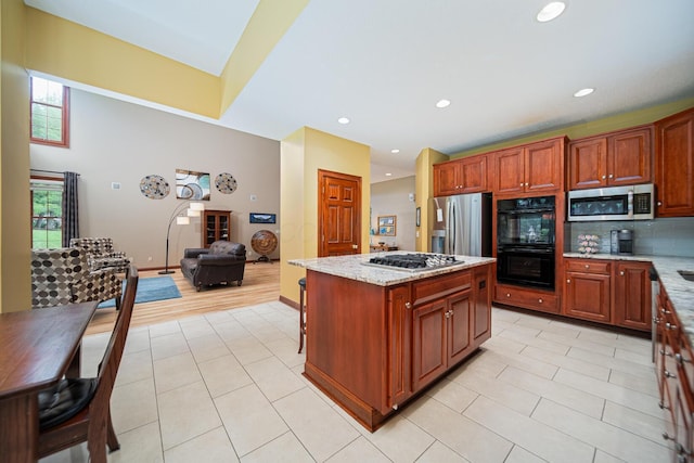 390 Engelwood Ct, Powell, OH 43065 - kitchen with stainless steel appliances, light tile patterned floors, healthy amount of natural light, a center island, and recessed lighting