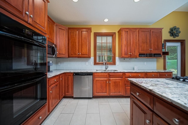 390 Engelwood Ct, Powell, OH 43065 - kitchen with appliances with stainless steel finishes, decorative backsplash, light stone counters, light tile patterned floors, and brown cabinets