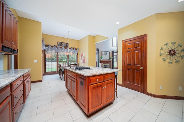 390 Engelwood Ct, Powell, OH 43065 - kitchen with light tile patterned floors, light stone counters, stainless steel gas stovetop, recessed lighting, and a center island
