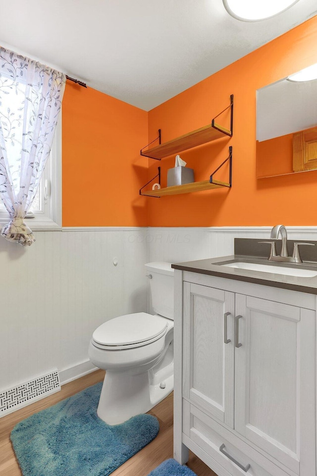 1200 Chanteloup Dr, Marion, OH 43302 - half bathroom featuring a wainscoted wall, toilet, wood finished floors, and vanity