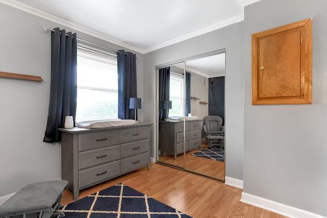 1200 Chanteloup Dr, Marion, OH 43302 - bedroom featuring a closet, light wood finished floors, ornamental molding, an office area, and baseboards