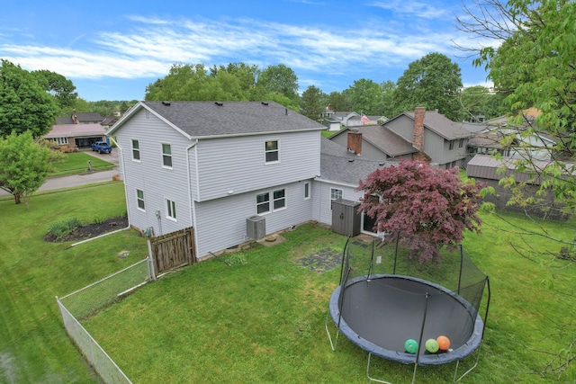 1200 Chanteloup Dr, Marion, OH 43302 - back of house with a trampoline, cooling unit, a shingled roof, and a residential view