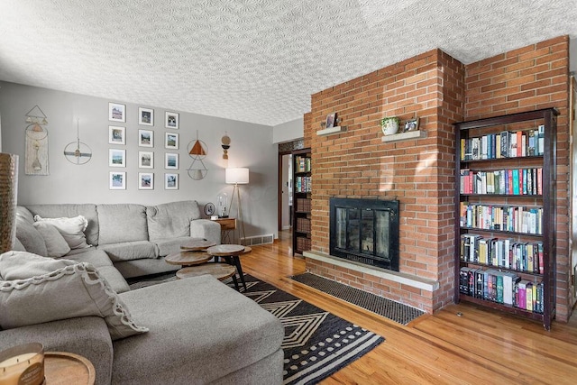 2690 Kingston Ave, Grove City, OH 43123 - living area featuring wood finished floors, a fireplace, and a textured ceiling