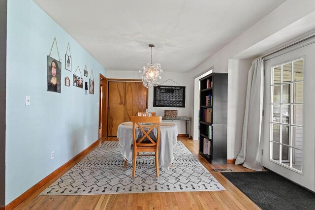 2690 Kingston Ave, Grove City, OH 43123 - dining room with a chandelier, light wood-type flooring, and baseboards