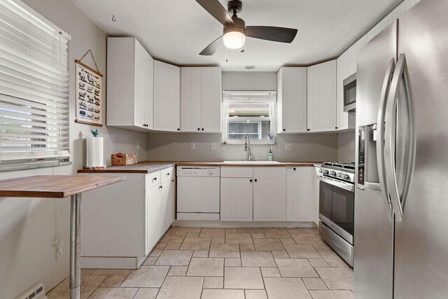 2690 Kingston Ave, Grove City, OH 43123 - kitchen with appliances with stainless steel finishes, a sink, ceiling fan, white cabinetry, and butcher block countertops