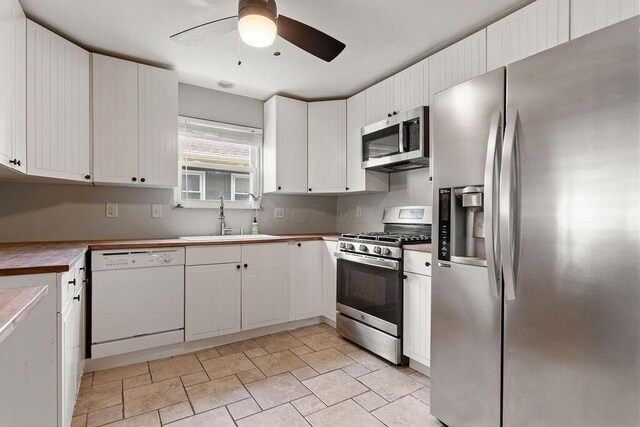 2690 Kingston Ave, Grove City, OH 43123 - kitchen featuring stainless steel appliances, a sink, a ceiling fan, white cabinetry, and light stone finish flooring