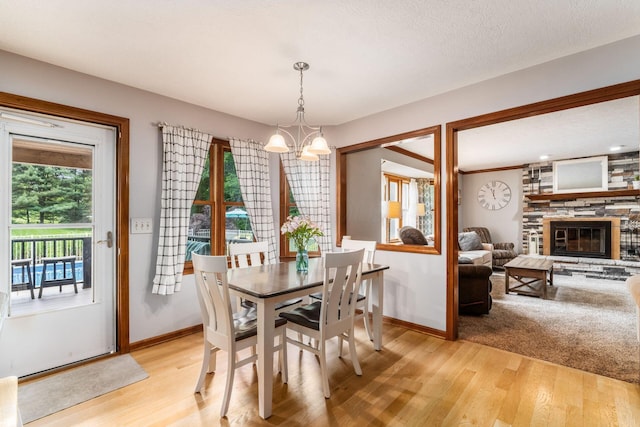1861 Ginder Rd NW, Lancaster, OH 43130 - dining room with light wood-type flooring, a chandelier, and baseboards