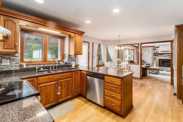 1861 Ginder Rd NW, Lancaster, OH 43130 - kitchen with dishwasher, a sink, brown cabinets, light wood finished floors, and a peninsula
