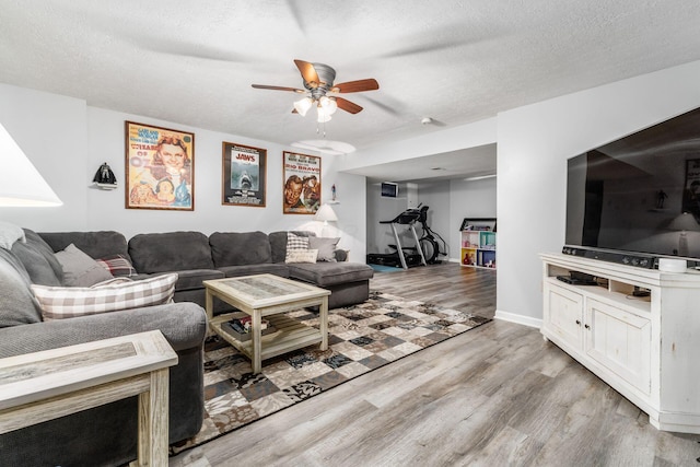 1861 Ginder Rd NW, Lancaster, OH 43130 - living room featuring wood finished floors, a ceiling fan, a textured ceiling, and baseboards