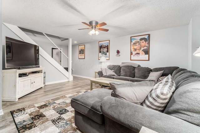 1861 Ginder Rd NW, Lancaster, OH 43130 - living area with stairs, light wood finished floors, ceiling fan, a textured ceiling, and baseboards