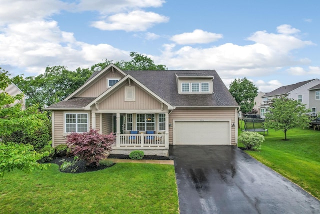 2079 Tournament Way, Grove City, OH 43123 - craftsman house featuring asphalt driveway, covered porch, a front lawn, roof with shingles, and board and batten siding