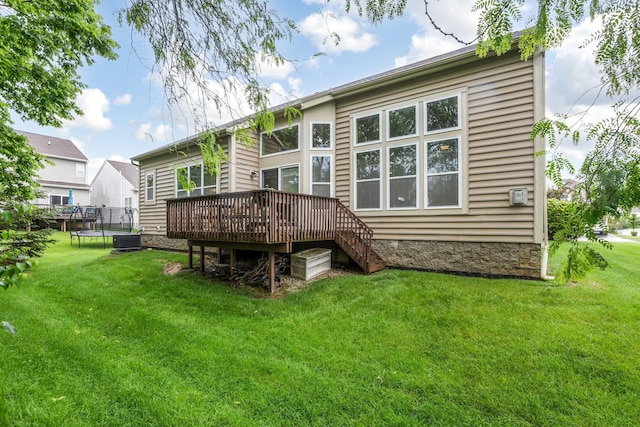 2079 Tournament Way, Grove City, OH 43123 - rear view of house with a trampoline, a deck, a yard, and central AC unit