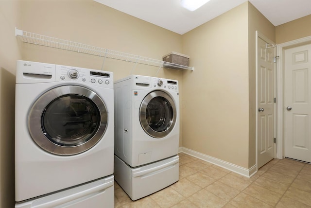 2079 Tournament Way, Grove City, OH 43123 - laundry room featuring separate washer and dryer, light tile patterned floors, and baseboards