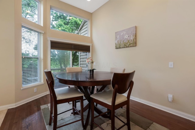 2079 Tournament Way, Grove City, OH 43123 - dining area with baseboards, wood finished floors, and a towering ceiling