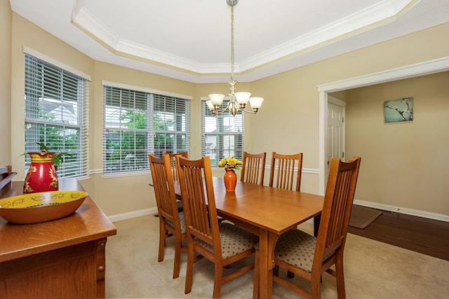 2079 Tournament Way, Grove City, OH 43123 - dining room with ornamental molding, a raised ceiling, a chandelier, baseboards, and light wood-style floors