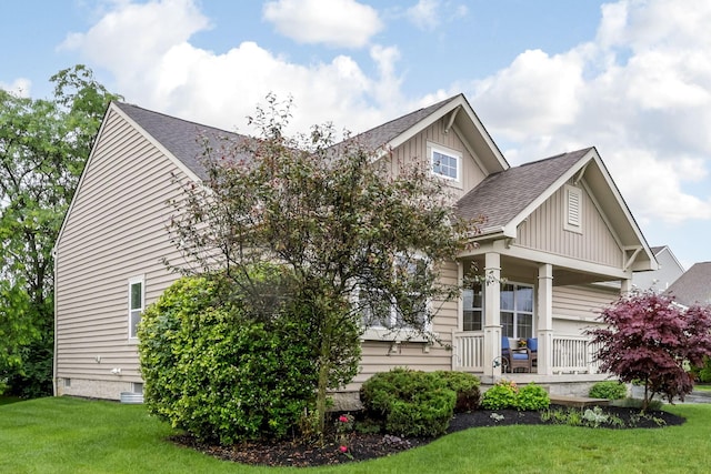 2079 Tournament Way, Grove City, OH 43123 - view of front of house with board and batten siding, covered porch, a front yard, and a shingled roof