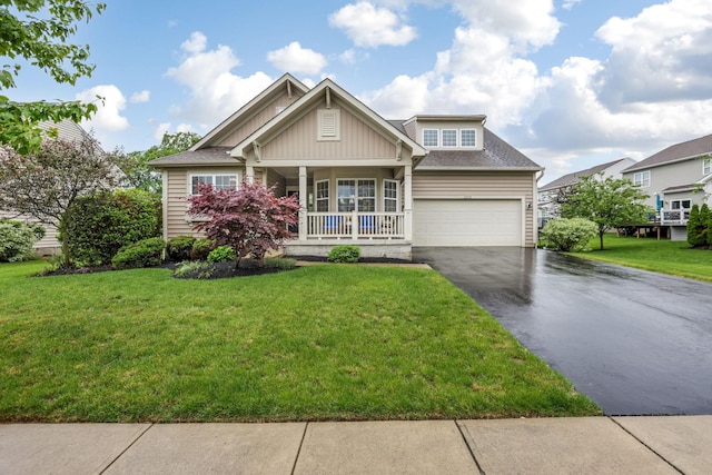 2079 Tournament Way, Grove City, OH 43123 - craftsman-style home with covered porch, asphalt driveway, a front yard, and a shingled roof