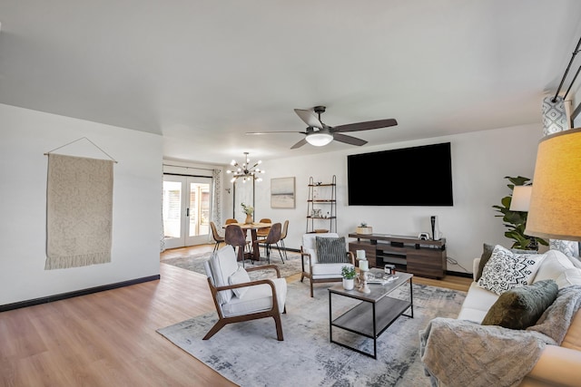600 Kappler Rd, Heath, OH 43056 - living area featuring light wood-style floors, a ceiling fan, a chandelier, and baseboards