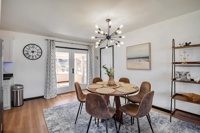 600 Kappler Rd, Heath, OH 43056 - dining area featuring french doors, a chandelier, light wood-style floors, and baseboards