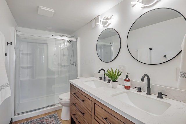 600 Kappler Rd, Heath, OH 43056 - bathroom featuring a shower stall, double vanity, toilet, and wood finished floors