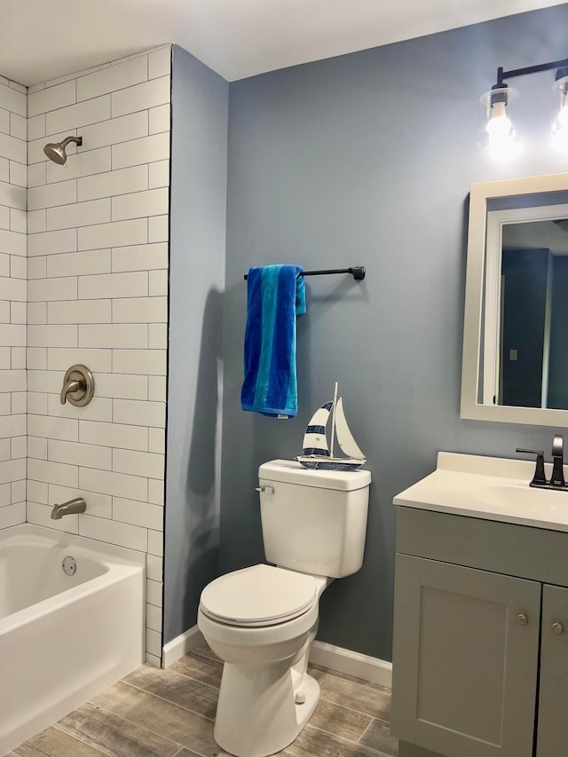 13212 Maple Rd NE, Thornville, OH 43076 - bathroom featuring wood finish floors, vanity, toilet, bathtub / shower combination, and baseboards