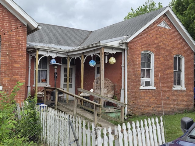 380 E 2nd St, Chillicothe, OH 45601 - view of front of house featuring brick siding, covered porch, roof with shingles, and cooling unit