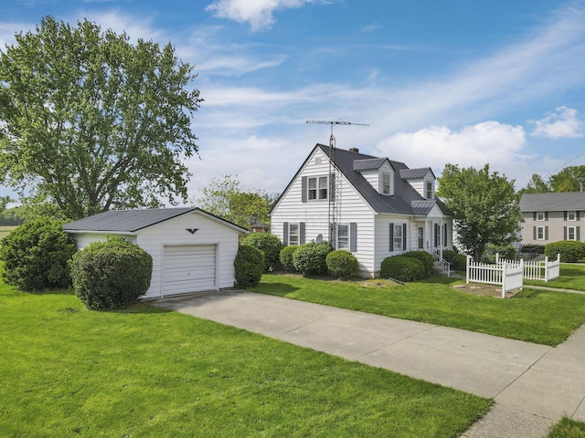 6880 Sandusky Ave, Chatfield, OH 44825 - cape cod house featuring an outbuilding, concrete driveway, metal roof, and a chimney