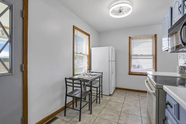6880 Sandusky Ave, Chatfield, OH 44825 - kitchen with white appliances, plenty of natural light, light tile patterned flooring, and light countertops