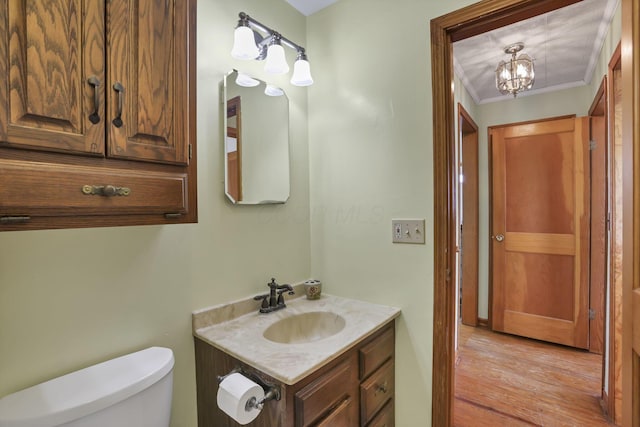 6880 Sandusky Ave, Chatfield, OH 44825 - half bathroom with vanity, toilet, a chandelier, and wood finished floors