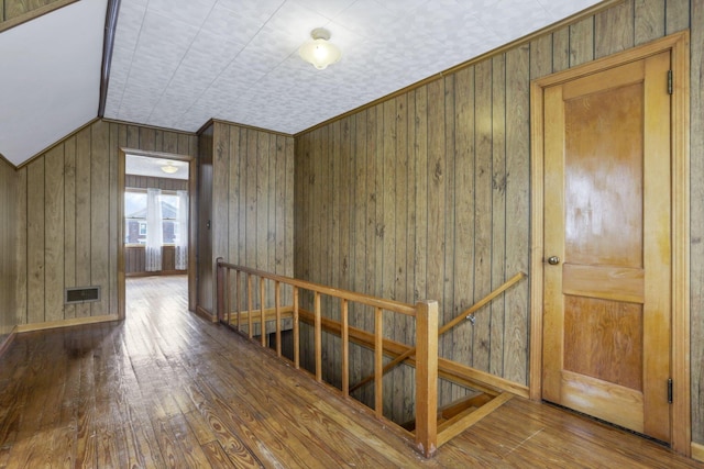 6880 Sandusky Ave, Chatfield, OH 44825 - corridor featuring an upstairs landing, hardwood / wood-style floors, wooden walls, and baseboards