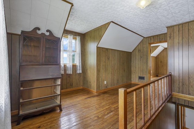 6880 Sandusky Ave, Chatfield, OH 44825 - additional living space featuring hardwood / wood-style floors, wooden walls, and baseboards