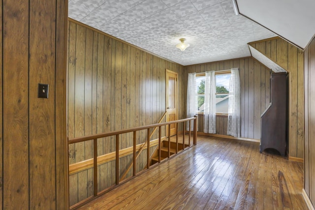 6880 Sandusky Ave, Chatfield, OH 44825 - spare room featuring hardwood / wood-style floors, wooden walls, and an ornate ceiling