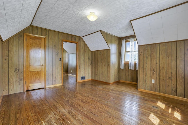 6880 Sandusky Ave, Chatfield, OH 44825 - additional living space with hardwood / wood-style flooring, wood walls, and baseboards