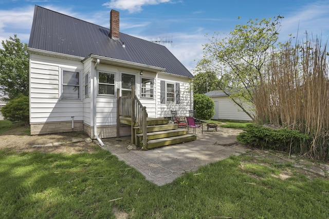 6880 Sandusky Ave, Chatfield, OH 44825 - rear view of property with a patio area, a lawn, a chimney, and metal roof