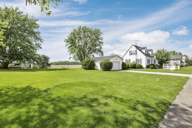 6880 Sandusky Ave, Chatfield, OH 44825 - view of grassy yard featuring driveway, an outdoor structure, and a garage