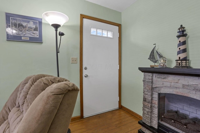 6880 Sandusky Ave, Chatfield, OH 44825 - foyer with wood-type flooring, baseboards, and a stone fireplace