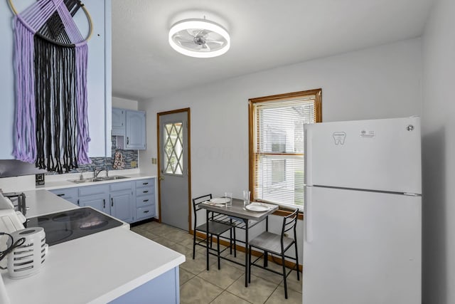 6880 Sandusky Ave, Chatfield, OH 44825 - kitchen with freestanding refrigerator, a sink, light tile patterned flooring, light countertops, and ceiling fan