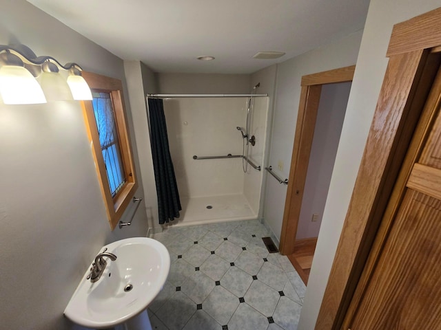 62 Scioto St, Powell, OH 43065 - bathroom featuring a stall shower and a sink