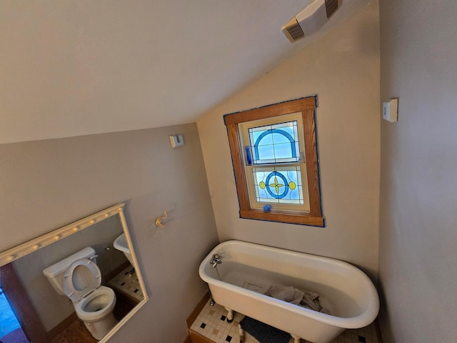 62 Scioto St, Powell, OH 43065 - bathroom with lofted ceiling, a freestanding tub, and baseboards