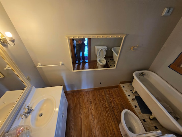 62 Scioto St, Powell, OH 43065 - full bathroom with a tub, vanity, a bidet, wood finished floors, and toilet