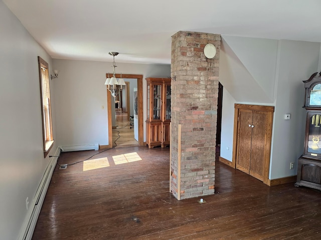 62 Scioto St, Powell, OH 43065 - unfurnished living room featuring baseboard heating, hardwood / wood-style floors, baseboards, and decorative columns