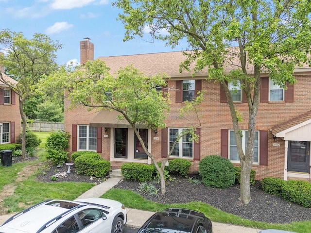 7914 Verandah Ct Unit 61, Powell, OH 43065 - view of front of property with a chimney, brick siding, and a shingled roof